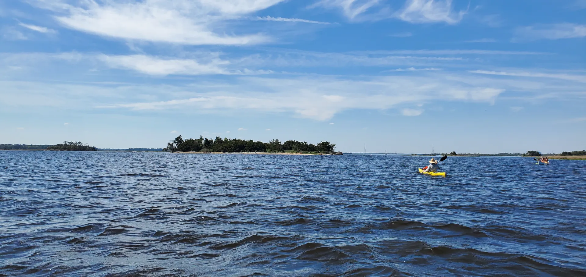 Kayaker paddling toward Shark Tooth Island on the Cape Fear River